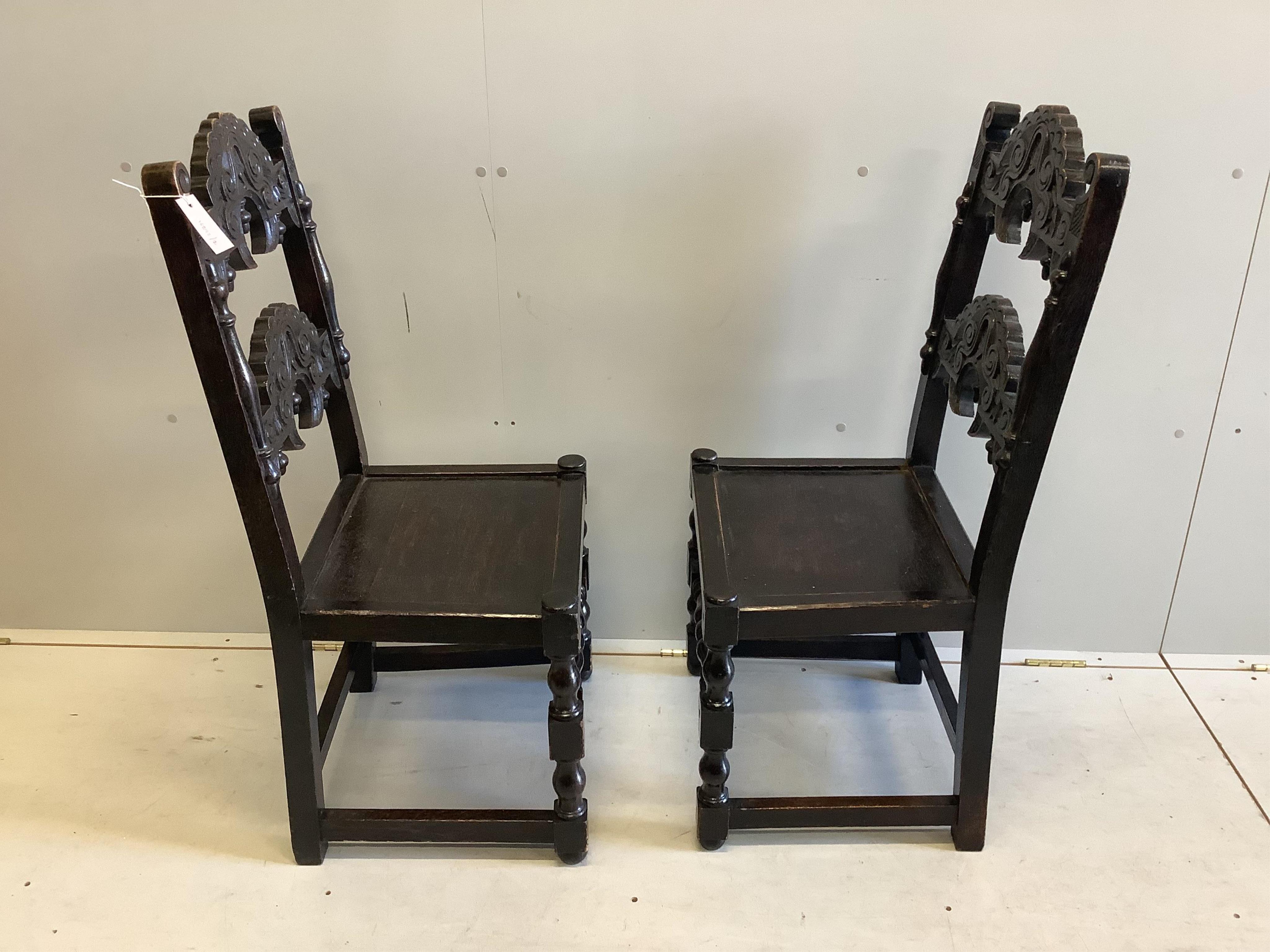 A pair of Derbyshire style oak side chairs, width 48cm, depth 41cm, height 102cm. Condition - fair